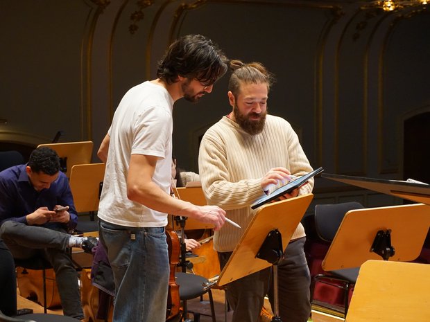 In-between rehearsals, the musicians discuss the score