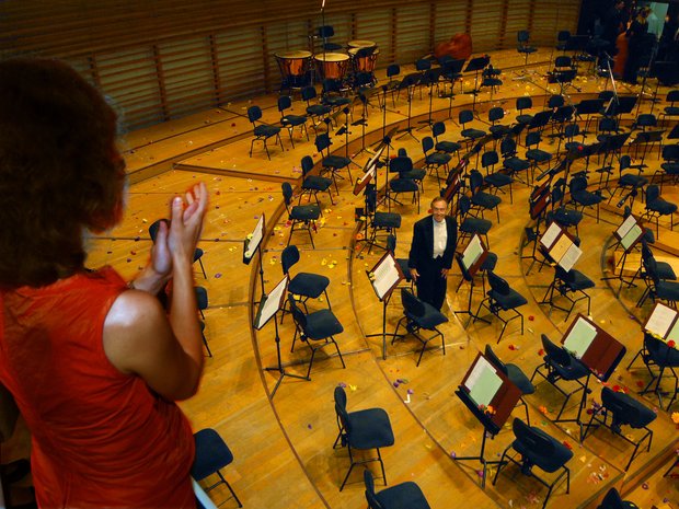 A member of the "Club Abbadiani Itineranti" throws flowers after a concert conducted by Claudio Abbado, 2006