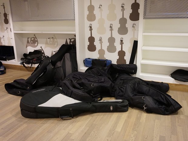 A small mountain of doublebass cases piled up in the hallway